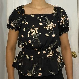 Black blouse with nude flowers.